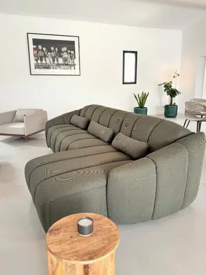 a living room with a couch and a table at La Villa des Glauges in Eyguières