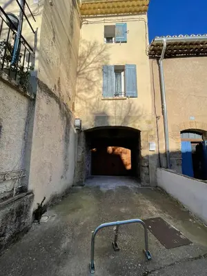 an empty parking lot with a gate in front of a building at Apartment in L'Isle-sur-la-Sorgue with parking in LʼIsle-sur-la-Sorgue