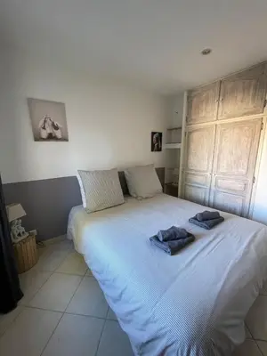 a bedroom with a large bed with two towels on it at Apartment in L'Isle-sur-la-Sorgue with parking in LʼIsle-sur-la-Sorgue