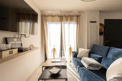 a living room with a blue couch and a table at Bella Vita Outdoor Jacuzzi in LʼIsle-sur-la-Sorgue