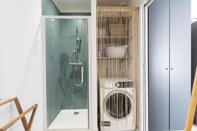 a bathroom with a shower and a fan at Bella Vita Outdoor Jacuzzi in LʼIsle-sur-la-Sorgue