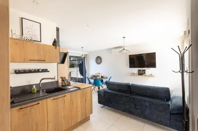a kitchen and a living room with a couch at Bella Vita Outdoor Jacuzzi in LʼIsle-sur-la-Sorgue