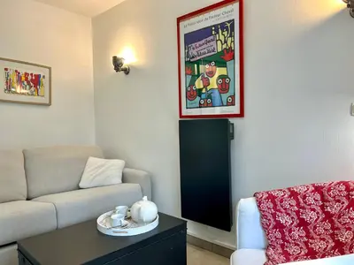 a living room with a couch and a table at La Bastide du Golfeur, Jardin et Piscine in Mallemort