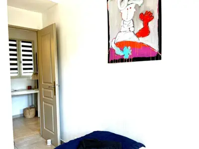 a painting of a woman in a dress hanging on a wall at La Bastide du Golfeur, Jardin et Piscine in Mallemort