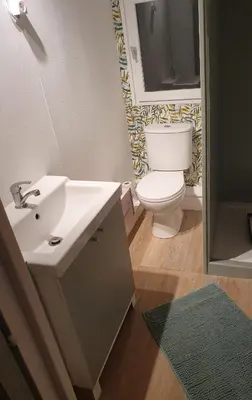 a bathroom with a white sink and a toilet at Chalet en provence