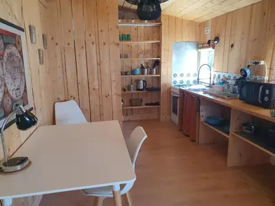 a kitchen with a table and a white table and chairs at Chalet en provence