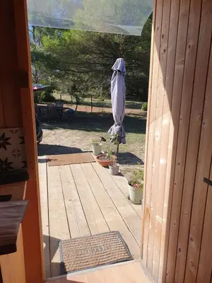 an open door with an umbrella and potted plants at Chalet en provence