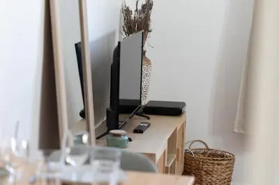 a room with a mirror and a tv on a table at Modern studio Le Renoir - Center of city - WiFi in Aix-en-Provence
