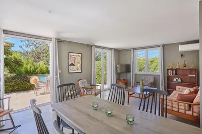 a living room with a wooden table and chairs at La Paulanne in Bonnieux