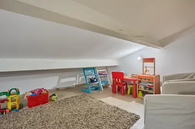 a living room with a couch and a table and chairs at La Paulanne in Bonnieux