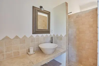 a bathroom with a bowl sink and a mirror at La Paulanne in Bonnieux
