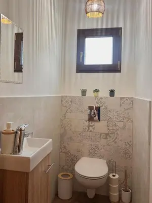 a bathroom with a white toilet and a sink at Esprit Lubéron, La Lavande, logement entier in Le Thor