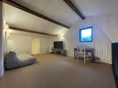 a living room with a television and a table at Luberon house with view in Cucuron