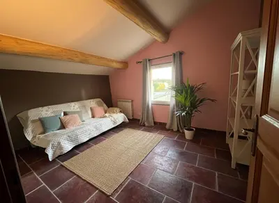 a living room with a couch and a window at Le Mas du Platane - logement deux chambres en Provence in Monteux