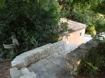 a woman standing on top of a stone wall at Holiday House Teulon in Éguilles