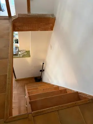 a room with wooden stairs in a room at L'essentiel - Studio cosy au cœur du centre ville historique d'Aix-en-Provence in Aix-en-Provence