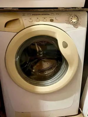 a close up of a washing machine with its door open at L'essentiel - Studio cosy au cœur du centre ville historique d'Aix-en-Provence in Aix-en-Provence