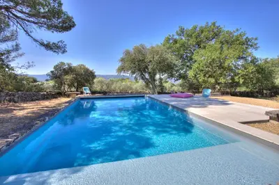 a swimming pool in a yard with trees at Bergerie provencale, 4 personnes, piscine in Gordes