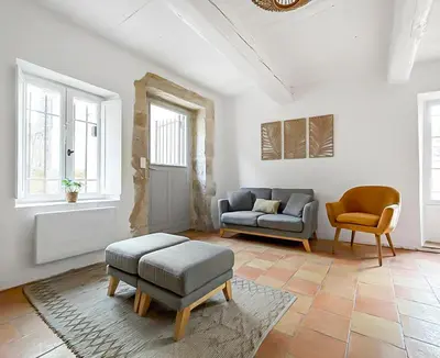 a kitchen with a island with chairs and a table at Maison rénovée avec terrasse et parking privé in Mallemort