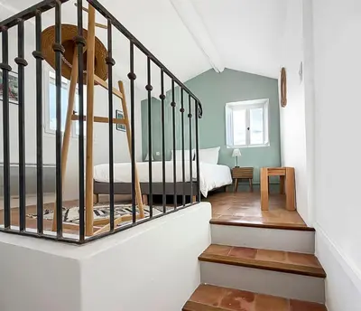a bedroom with a bed and a staircase in a room at Maison rénovée avec terrasse et parking privé in Mallemort
