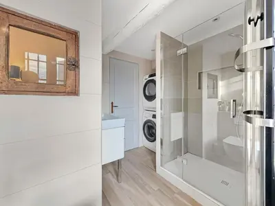 a bathroom with a sink and a washing machine at Maison rénovée avec terrasse et parking privé in Mallemort