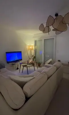 a living room with a large couch and a tv at Jolie maison tout confort in Monteux