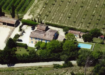 an aerial view of a house with a swimming pool in a field at Mas Provençal - 300 m2 - 7 chambres in Cavaillon
