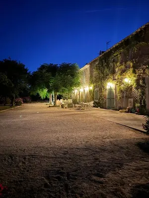 a building with a courtyard at night with lights at Farm House, 10 min d'Avignon in Jonquerettes