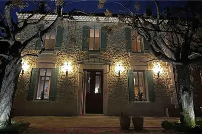 a building with a front door at night at Farm House, 10 min d'Avignon in Jonquerettes