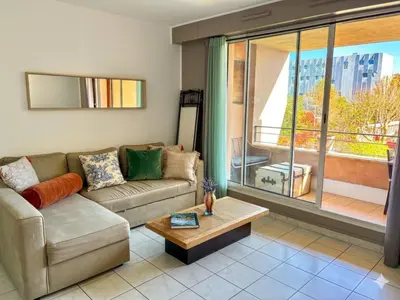 a living room with a table and a couch at Calme T2, Wifi, Proche centre et sites culturels, Vue magnifique in Aix-en-Provence
