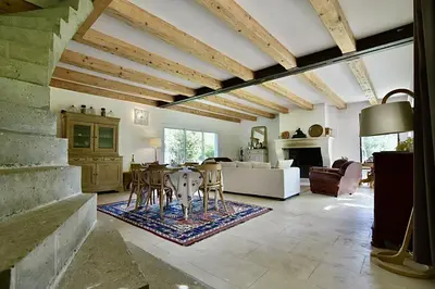 a large living room with a table and chairs at Maison Satine in Noves