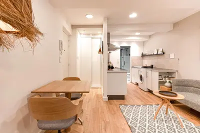 a kitchen and living room with a table and chairs at Appartement Aix centre ville in Aix-en-Provence