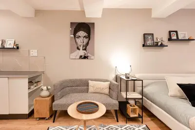a living room with a couch and a chair at Appartement Aix centre ville in Aix-en-Provence