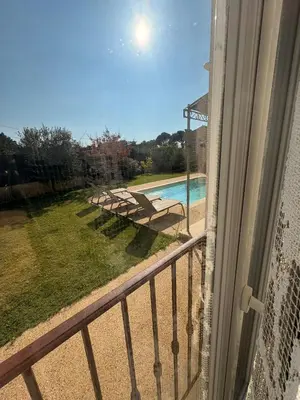 a balcony with a view of a swimming pool at Farniente à Valloncourt in Cheval-Blanc