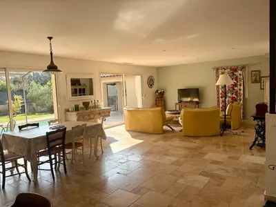 a living room with a table and yellow chairs at Farniente à Valloncourt in Cheval-Blanc