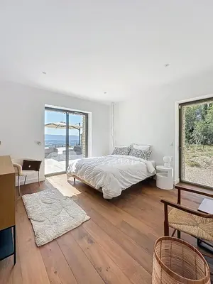 a white bedroom with a bed and a large window at 180 Grand Luberon Gordes vue panoramique in Gordes