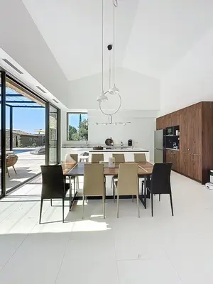 a kitchen and dining room with a table and chairs at 180 Grand Luberon Gordes vue panoramique in Gordes