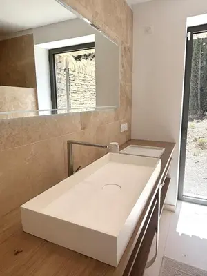 a white sink in a bathroom with a mirror at 180 Grand Luberon Gordes vue panoramique in Gordes