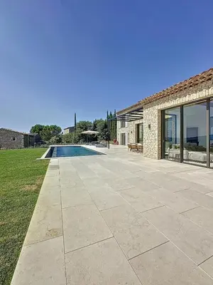 a patio with a swimming pool next to a house at 180 Grand Luberon Gordes vue panoramique in Gordes