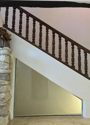 a glass window under the stairs in a house at Domaine De Pradaous in Reillanne