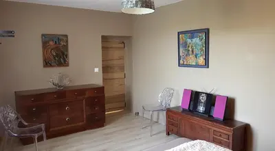 a bedroom with a dresser with a tv on it at Domaine De Pradaous in Reillanne