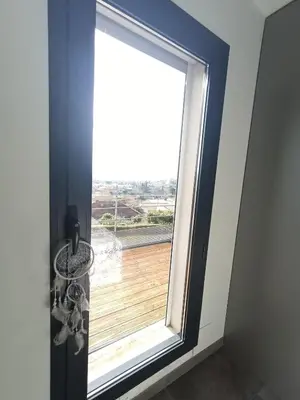 a room with a large window and a green shelf at Villa ChloLéa in Caromb