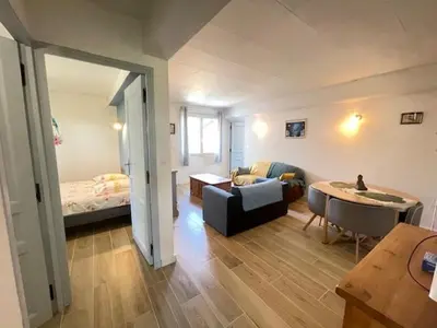 a living room with a couch and a bed at La Treille cozy villa basement in Provence in Sainte-Tulle