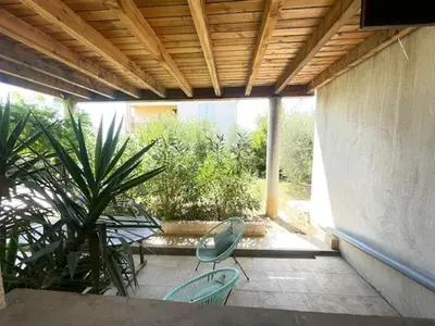 a patio with two chairs and a plant at La Treille cozy villa basement in Provence in Sainte-Tulle