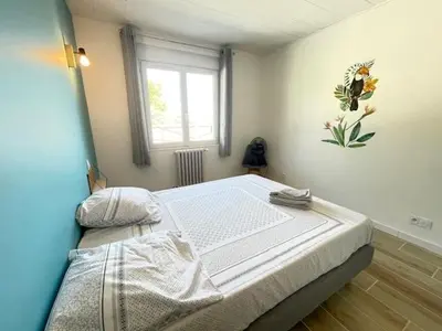 a bedroom with a bed in a room with a window at La Treille cozy villa basement in Provence in Sainte-Tulle