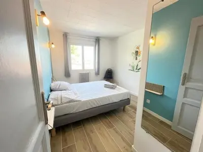 a small bedroom with a bed and a window at La Treille cozy villa basement in Provence in Sainte-Tulle