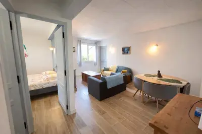 a living room with a room with a bed and a table at La Treille cozy villa basement in Provence in Sainte-Tulle
