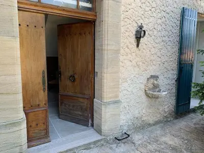 an entrance to a building with two wooden doors at La Commanderie du Ventoux in Mormoiron
