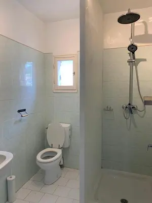 a bathroom with a toilet and a sink and a shower at La Commanderie du Ventoux in Mormoiron