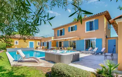 a villa with a swimming pool and a house at Maison Avec Piscine Privée in Villars